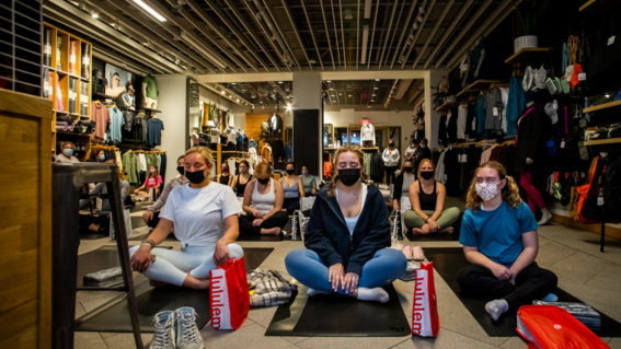 Katrina and her supporters do yoga at lululemon 
